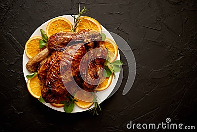 Roasted whole chicken or turkey served in white ceramic plate with oranges Stock Photo