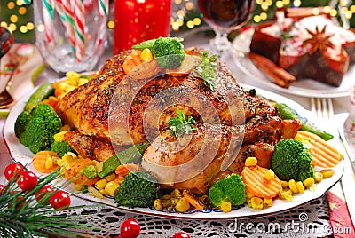 Roasted whole chicken with vegetables on christmas table Stock Photo