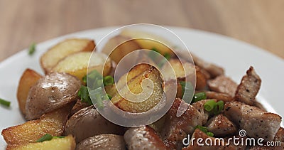 Roasted young potatoes with fried pork and green onion Stock Photo