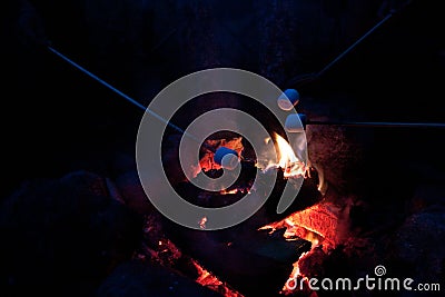 Roasting marshmallows at a campfire Stock Photo