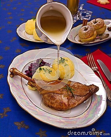 Roasty duck leg with braised red cabbage and dumplings Stock Photo