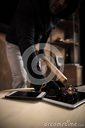 Robber stealing valuables Stock Photo