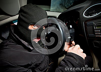 Robber and the thief in a mask hijacks the car Stock Photo