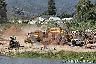 Tractor trailer working on tree shredding site on Breede River. Editorial Stock Photo