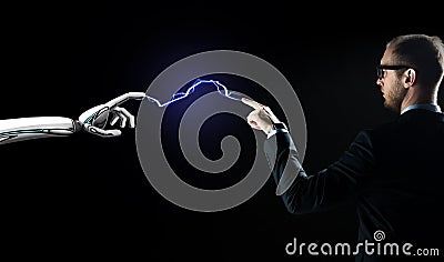 Robot and businessman connected by lightning Stock Photo