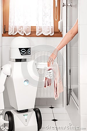 Robot is giving a towel to an women Stock Photo