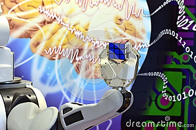 A robot hand holding a Rubik`s Cube with the abstract background Editorial Stock Photo