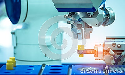 Robot hand machine gripping simulated object on blurred background. Use smart robot in manufacturing industry. Robotic tool Stock Photo