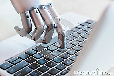 Robot hands and fingers point to laptop button advisor chatbot robotic artificial intelligence Stock Photo