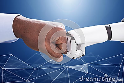 Robot And Human Hand Making Fist Bump Stock Photo