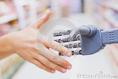 Robot and human hands in handshake, high tech in everyday life Stock Photo