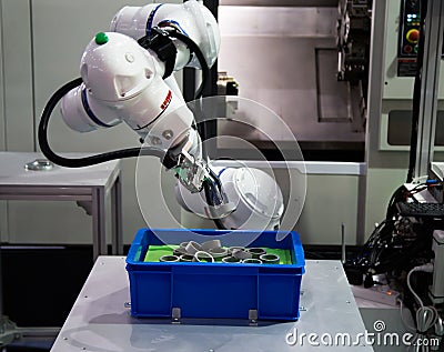 Robot loading workpiece to CNC machine Stock Photo