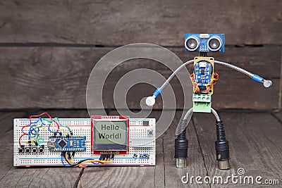 Robot made of parts of circuit boards with wrench near the debug Stock Photo