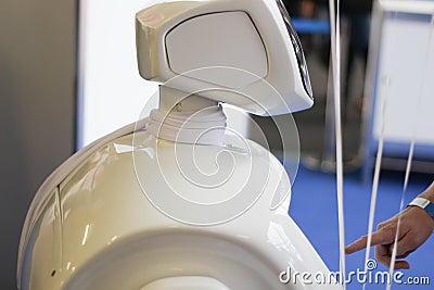 Robot, new model that joins the exclusive club of humanoid robots. The touch screen, curvy design.Service robots. Android robot t Stock Photo