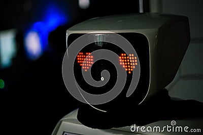 Robot with red eyes heart shape. Future, love and robotic concept. Love robot Stock Photo