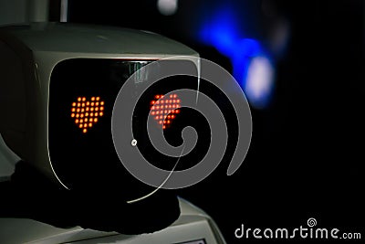 Robot with red eyes heart shape. Future, love and robotic concept. Love robot Stock Photo