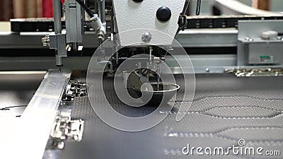 Robot sewing machine. automatic sewing machine. Robotics works in the tailoring production line. The computer controls Stock Photo