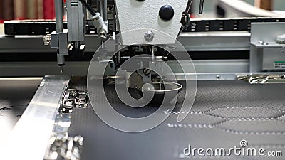 Robot sewing machine. automatic sewing machine. Robotics works in the tailoring production line. The computer controls Stock Photo