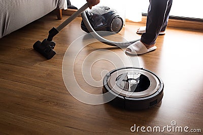 Robot vacuum cleaner with people mop the floor.Smart life Stock Photo