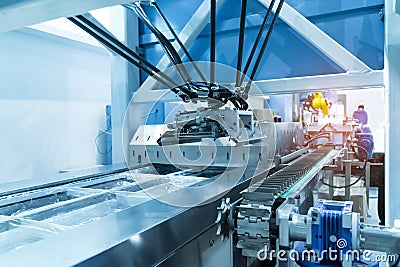 Robot with vacuum suckers with conveyor in manufacture factory Stock Photo