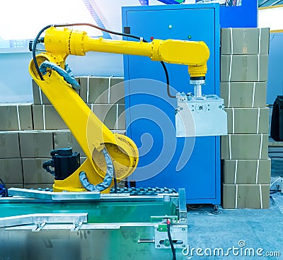 Robot with vacuum suckers with conveyor in manufacture factory Stock Photo