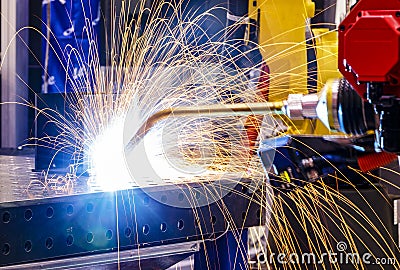 Robot welding process close up Laser cutting of metal on robotic arm with sparks Stock Photo