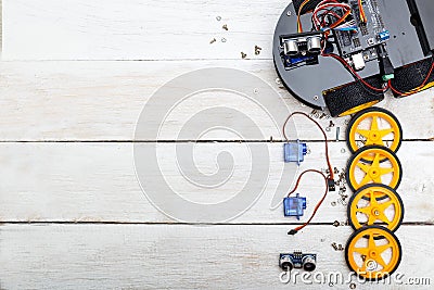 Robot with wheels and the elements necessary for the robot assembly. Flat lay Stock Photo