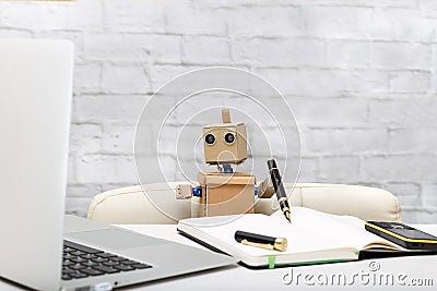 Robot working at a computer; workplace Stock Photo