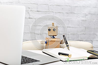 Robot working at a desk. the working process Stock Photo