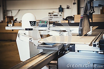 A robot works fully automatically in a carpentry workshop Stock Photo