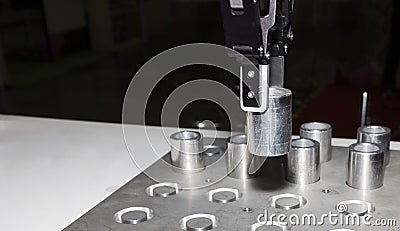 Robotic arm clamp sample and transfer in metal plate Stock Photo