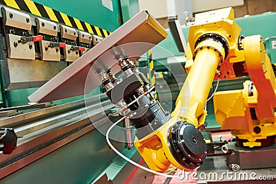 Robotics in hydraulic press brake or bending machine for sheet metal. Stock Photo