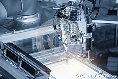 The robotic arm use in electronics production line with the lighting effect. Stock Photo