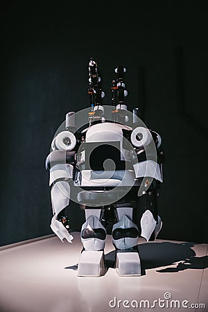 a robot that is sitting in the light on the floor Stock Photo