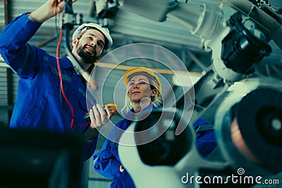 Robotic technician control automation works within accepted limits by testing operating voltages and electrical configurations. Stock Photo