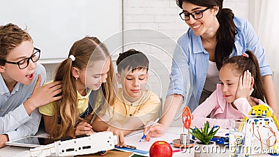 Stem education. Children studying at robotic class, making notes Stock Photo