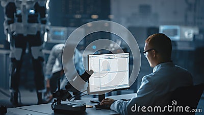 In Robotics Development Laboratory: Chief Analyst Uses Computer, Top Male Scientist Work on Bionic Stock Photo