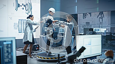 In Robotics Development Laboratory: Engineers and Scientists Work on a Bionics Exoskeleton Prototy Stock Photo
