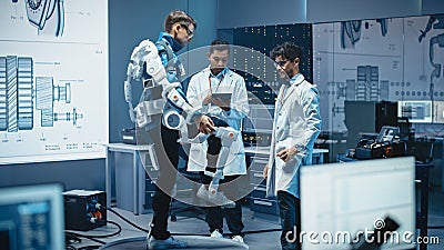 In Robotics Development Laboratory: Engineers and Scientists Work on a Bionics Exoskeleton Prototy Stock Photo