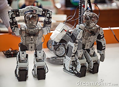 Robotis Bioloid, Premium kit: 2 small programmed DIY humanoid robot toys standing on a table close-up Editorial Stock Photo