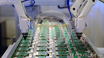 Robots equipped with 3D vision technology accurately positioning and assembling layers of electronic circuits within a Stock Photo