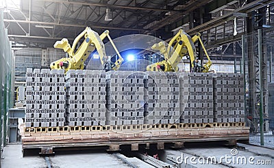 Robots manipulators stack bricks in a brick factory in a workshop Stock Photo