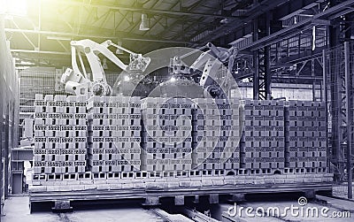 Robots manipulators stack bricks in a brick factory in a workshop Stock Photo