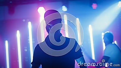 Rock Band Performing at a Concert in a Night Club. Portrait of a Lead Singer Singing into Micropho Stock Photo