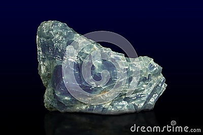 Rock of blue calcite mineral on dark background Stock Photo