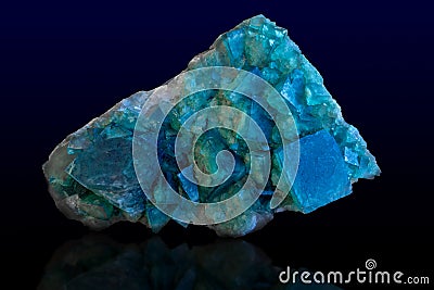 Rock of blue calcite mineral on dark background. Stock Photo