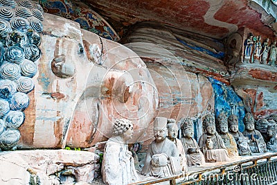 Rock carving of Sakyamuni Buddha entering Nirvana, with his disciples Stock Photo
