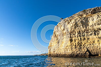 Rock and cliff coast under a brigh blue sky with sea caves on the Atlantic coast Stock Photo