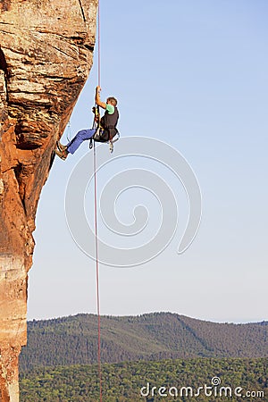 Rock climber and photographer rappeling from a sandstone rock Stock Photo