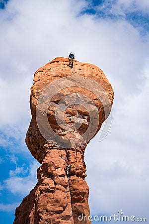 Rock climber on top of a hoodoo, Utah Editorial Stock Photo